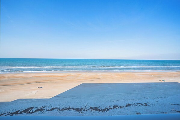 A beach with a clear sky and calm sea. - #506 Southpoint 2/2 Oceanfront Condo (Ponce Inlet)