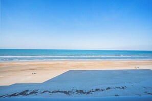 A beach with a clear sky and calm sea. - Southpoint 506 in Ponce Inlet, FL (Ponce Inlet)