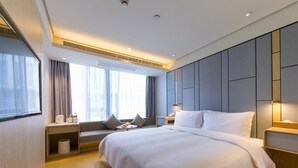 A modern hotel room with a large bed, bedside tables, a window with curtains, and a built-in headboard. - JI Hotel (Hangzhou West Lake Hubin Jiefang Road) (Hangzhou)