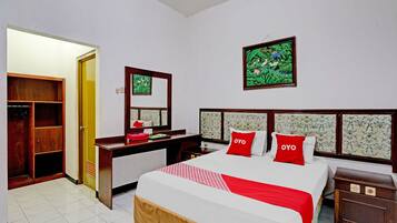 A hotel room with a bed, a desk, a wardrobe, and a bathroom.