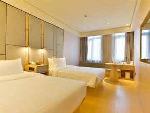 A hotel room with two beds, a desk, a chair, and a large window with curtains. - JI Hotel Shanghai Wujiaochang Shiguang Road (Shanghai)