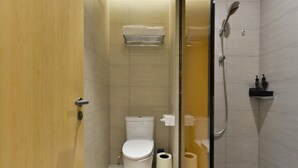 A small, modern bathroom with a toilet, a shower, and a towel rack. - JI Hotel Shanghai Wujiaochang Shiguang Road (Shanghai)
