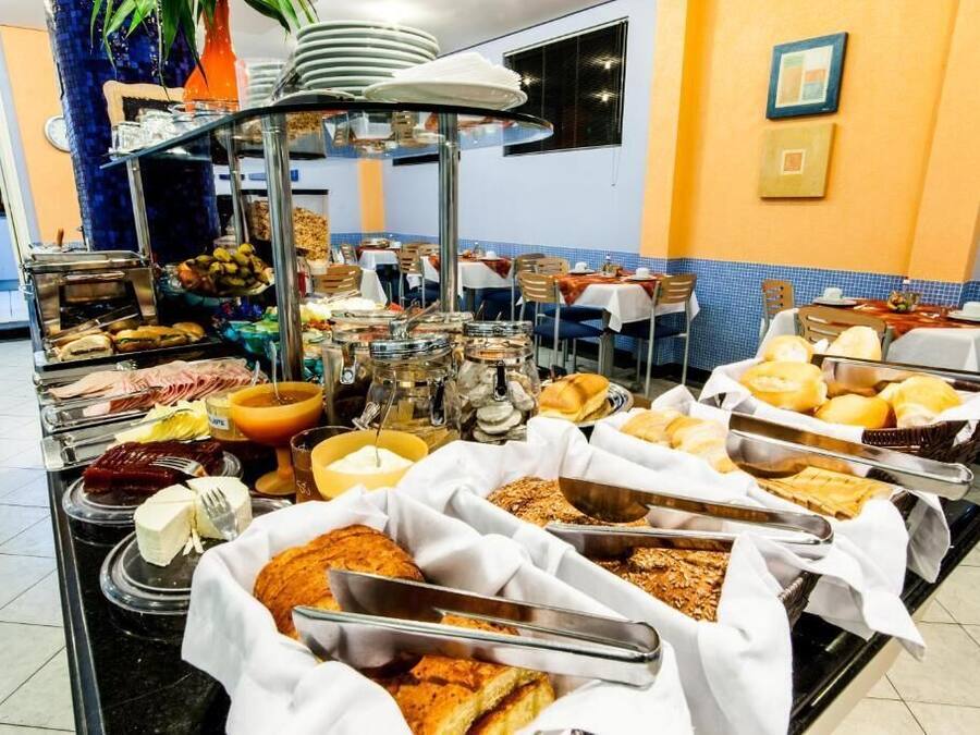 A buffet setup with various food items and utensils.