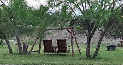Cozy Tiny Cabin with a small porch and firepit.