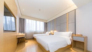 A modern hotel room with a large bed, bedside tables, a desk with a chair, and a large window with curtains. - JI Hotel Shanghai The Bund Jiujiang Road (Shanghai)