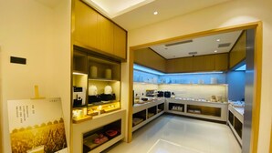 A modern hotel kitchen with a clean layout, equipped with various appliances and storage for food and beverages. - JI Hotel Shanghai The Bund Jiujiang Road (Shanghai)