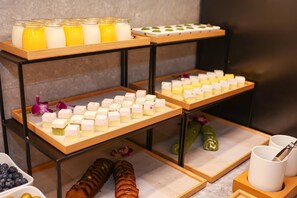 A buffet setup with various food items and drinks. - JI Hotel Shanghai The Bund Jiujiang Road (Shanghai)