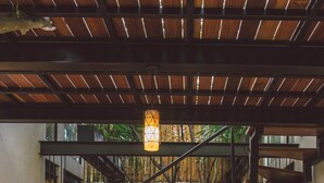 A staircase with a metal railing leading to a stone wall, surrounded by greenery. - TreeHouse Boutique Hotel - Adults Only  (Mérida)