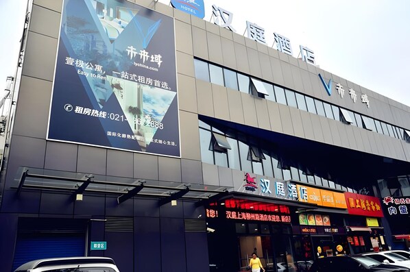 A hotel building with a large advertisement for a rental service.