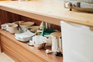 A kitchen counter with various dishes, a coffee maker, and a kettle. - Lovingly guest apartments Alpirsbach - Apartment 3 (Alpirsbach)