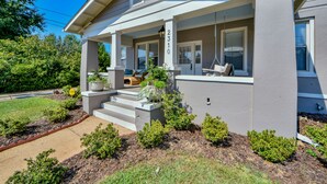 A two-story house with a porch, number 2310, and a well-maintained front yard with shrubs and a sidewalk. - Oak - Walk to the Stadium!  Backyard with firepit & grill (Tuscaloosa)