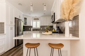 Microwave, dishwasher, coffee/tea maker, cookware/dishes/utensils