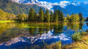 A mountain landscape with a lake reflecting trees and mountains. - Cham Sud Grepon102 Mountain-View Balcony for 4, Chamonix, France (Chamonix)