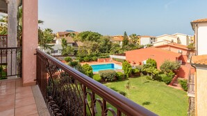 A residential area with a swimming pool, greenery, and houses. - Apartment  Azalea with Balcony & Wi-Fi (Valledoria)
