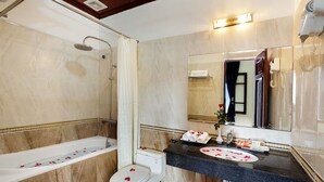A bathroom with a bathtub, toilet, and sink. - Hanoi Posh Hotel (Hanoi)