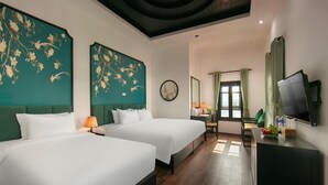 A hotel room with two beds, a desk with a television, and a dining area with a window. - Hanoi Posh Hotel (Hanoi)