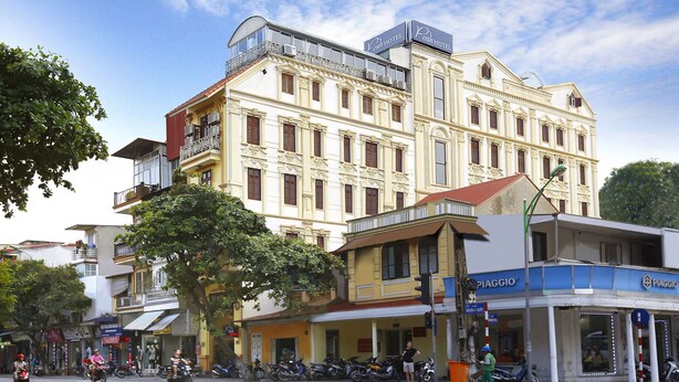 A multi-story hotel with a classic architectural style, featuring balconies and large windows. - Hanoi Posh Hotel (Hanoi)