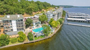 A waterfront hotel with a swimming pool, a dock, and a view of the water. - HT901 - Impressive lakefront condo! (Lake Ozark)