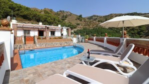 A rooftop pool area with lounge chairs, an umbrella, and a view of the surrounding landscape. - 1200 Villa el Barco (Nerja)