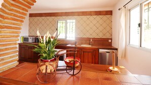 A kitchen with a wooden island, a microwave, and a sink. - 1200 Villa el Barco (Nerja)