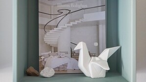 A framed artwork of a modern interior with a spiral staircase, a bed, and a white sculpture. - Perfect location, cosy and stylish and with one of the largest bathrooms i town (København)