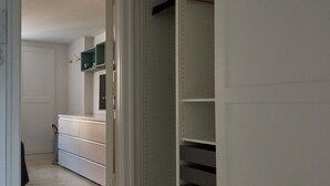 A hallway with a wooden floor leading to a bedroom with a bed and a wardrobe. - Perfect location, cosy and stylish and with one of the largest bathrooms i town (København)