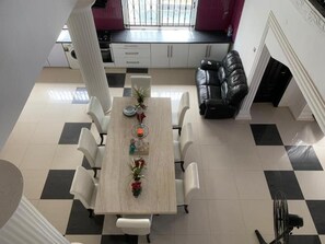 Enjoy meals with friends and family in this spacious dining area, featuring a stylish table for six and comfortable seating.