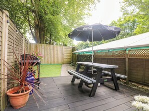 A wooden deck with a picnic table and a Coca-Cola branded umbrella. - Robin's Nest at The Shire Inn (Camborne)
