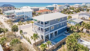 A multi-story beachfront property with a pool, balconies, and a view of the ocean. - Luxury Gulf View Home with Private Pool! Steps to the beach! (Pensacola Beach)