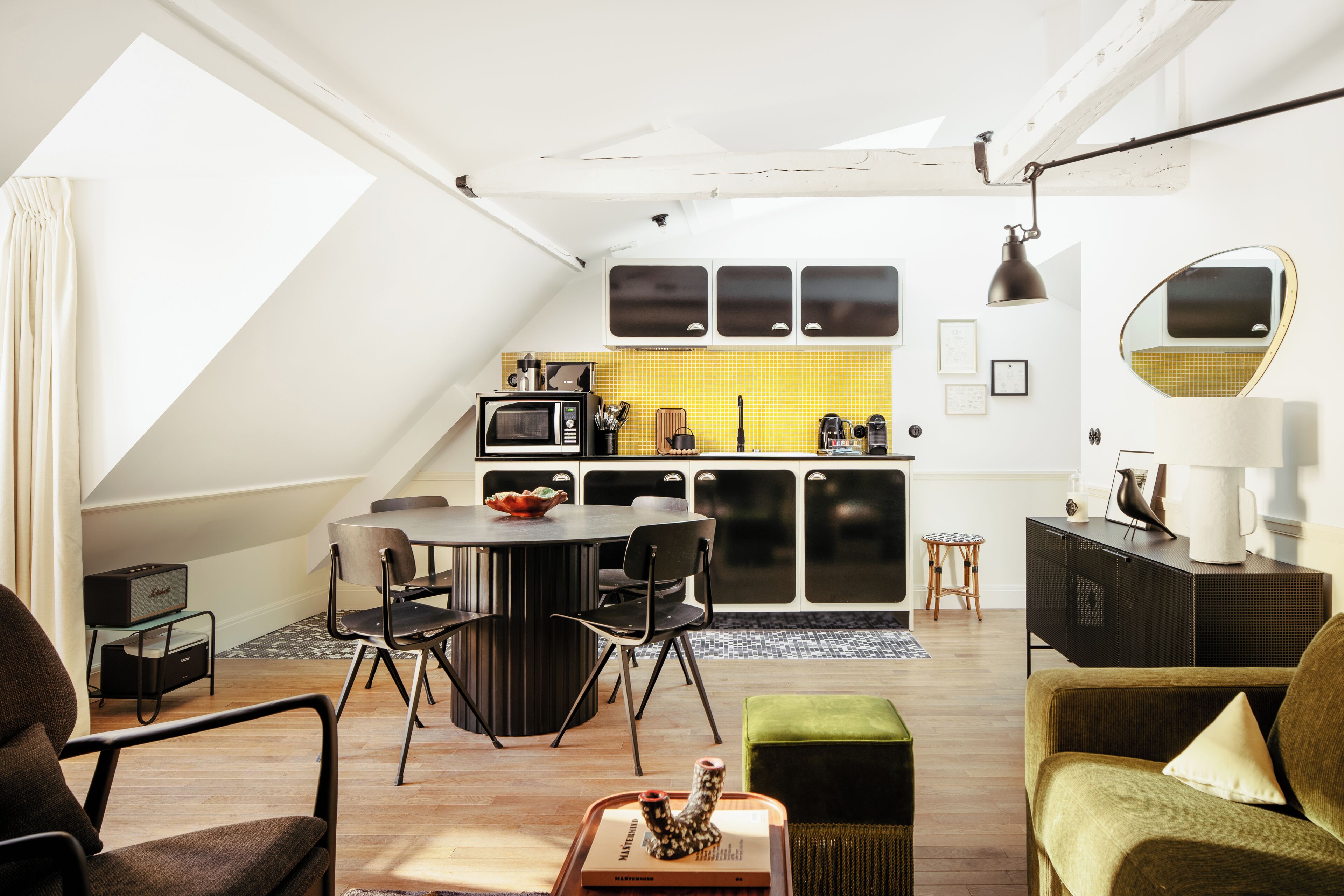 A modern loft apartment with a kitchen, dining area, and living space.
