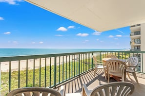 A balcony with a view of the beach and ocean. - 4-bedroom, 3-bathroom, oceanfront unit, sleeps 10 | Ocean Bay Club - 401 (North Myrtle Beach)
