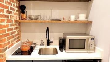 Fridge, microwave, coffee/tea maker, cookware/dishes/utensils