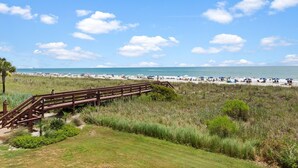 A beach with a wooden boardwalk leading to the shore, sandy beach, and ocean view. - First Floor Corner Unit, 3-bedroom/3-bath condo | Beach Club - 1E (North Myrtle Beach)