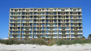 A multi-story hotel with numerous balconies, located near a sandy beach. - First Floor Corner Unit, 3-bedroom/3-bath condo | Beach Club - 1E (North Myrtle Beach)