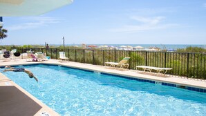 A swimming pool with clear blue water, surrounded by lounge chairs and a view of the ocean. - Well designed 6th floor, 3-bedroom, 3-bath oceanfront condo | Crescent Tower 1 - 601 (North Myrtle Beach)