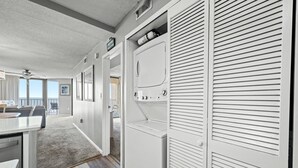 A hotel room with a kitchenette, a large window, and a view of the ocean. - Calming paint palette and stylish design, 3-bedroom, 3-bath, sleeps 8, oceanfront condo | Summit -3D (North Myrtle Beach)