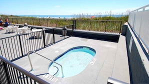A rooftop pool with a view of the beach and ocean. - 3-bedroom, 2-bathroom, oceanfront condo, Plenty of updates and upgrades | Sea Castle - 5C (North Myrtle Beach)