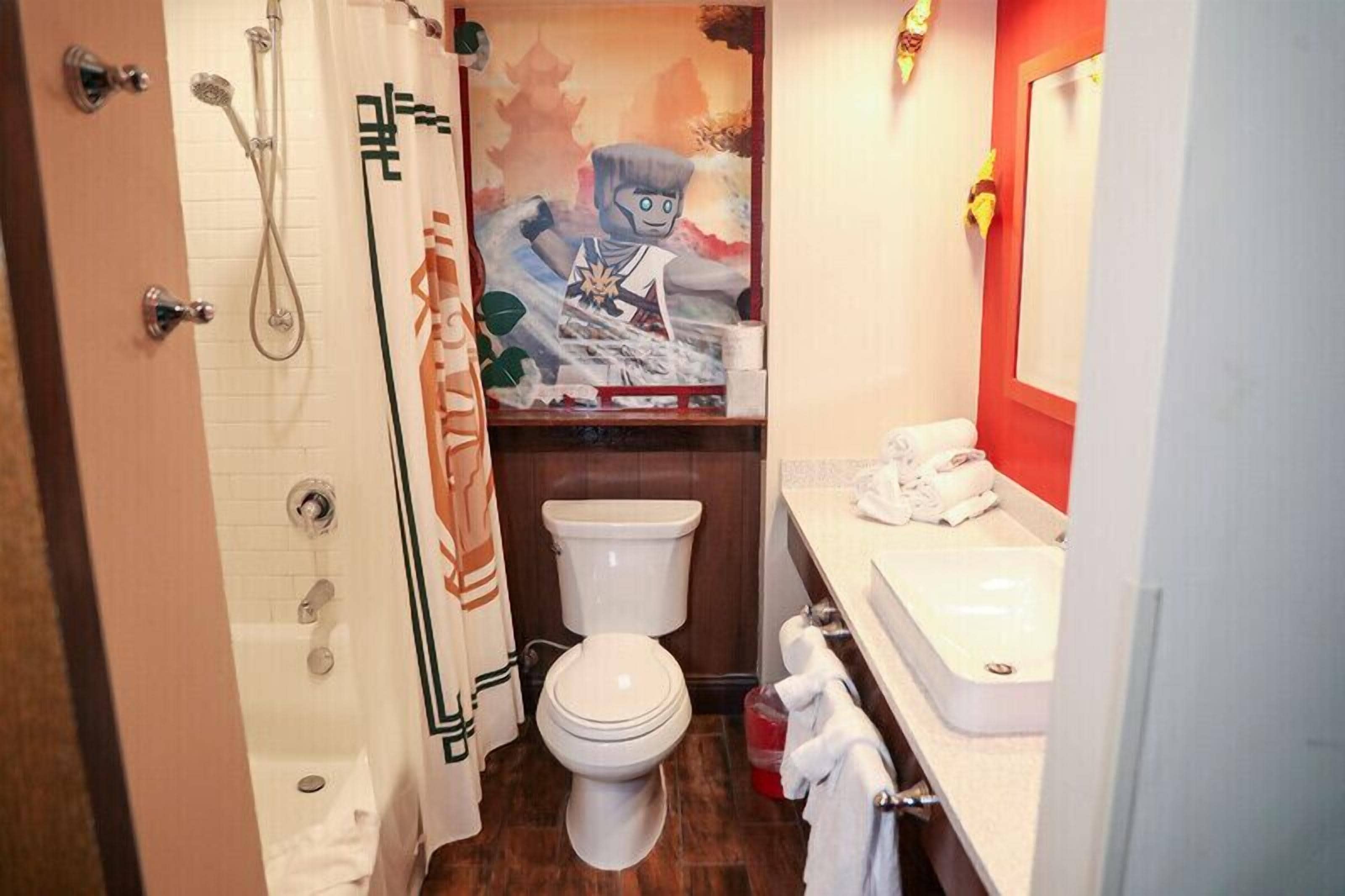 A bathroom with a shower, toilet, and sink.