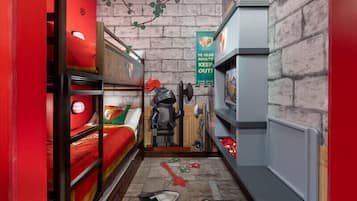 A narrow room with bunk beds, a radiator, and a wall-mounted shelf.