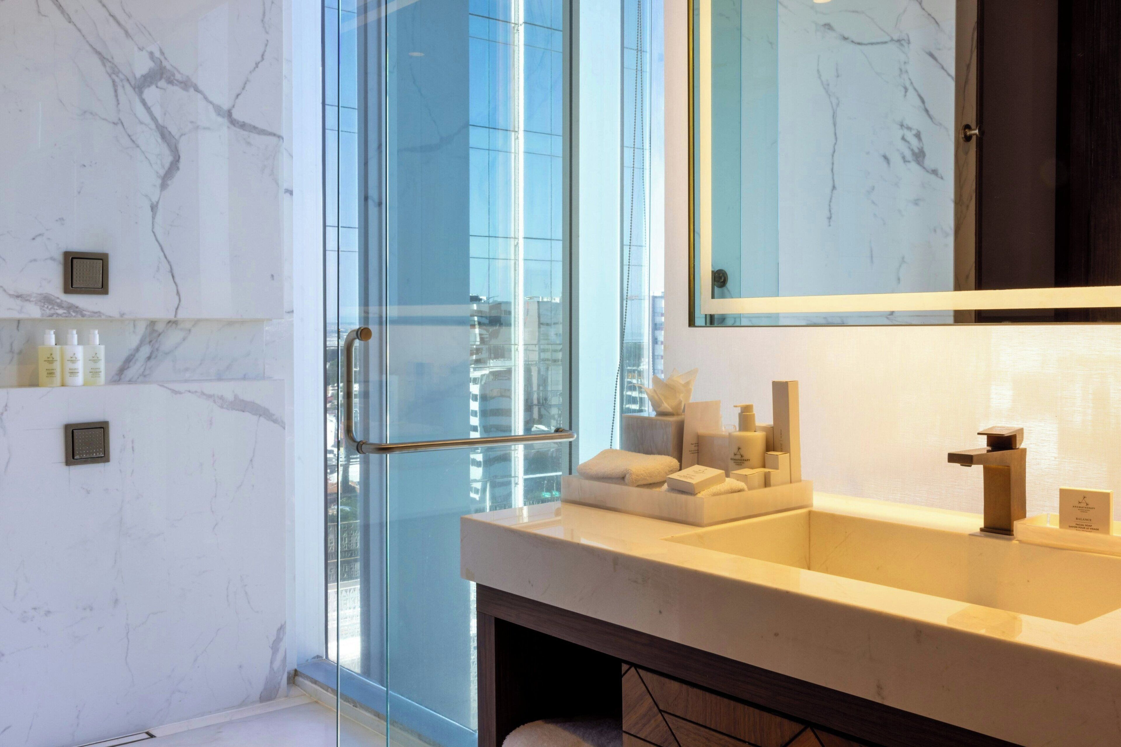 deluxe room, 1 double bed, corner | bathroom | rainfall showerhead, hair dryer, slippers, towels