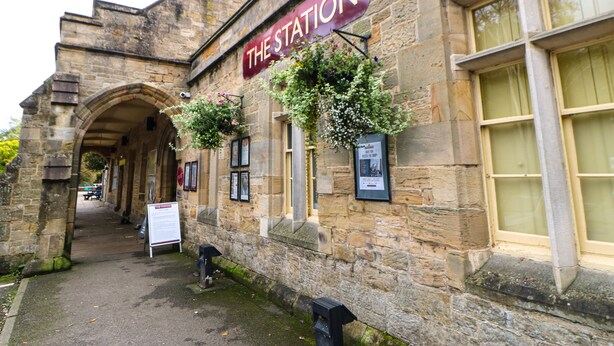 A stone building with a sign reading "THE STATION". - Bridgedown House (Richmond)
