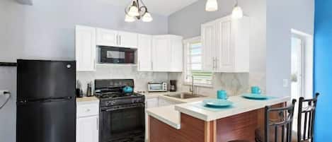 Fridge, microwave, coffee/tea maker, cookware/dishes/utensils