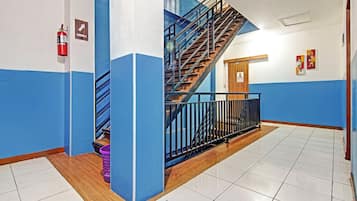 A multi-level interior with a staircase, a fire extinguisher, and a door marked 'WALTER'.