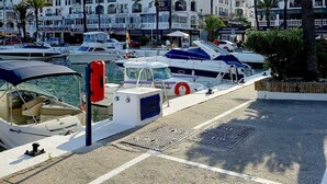 A marina with boats docked, a lifebuoy, and buildings with balconies in the background. - 3 bedroom apartment in San Luis de Sabinillas (San Luis de Sabinillas)