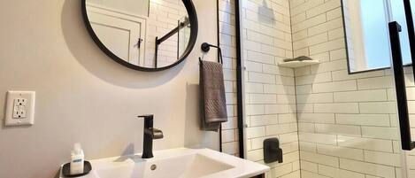 Bathtub, hair dryer, towels, shampoo