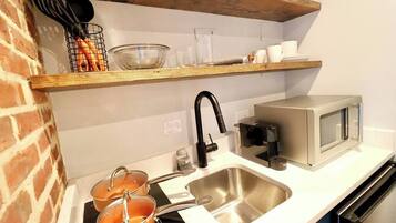 Fridge, microwave, coffee/tea maker, cookware/dishes/utensils