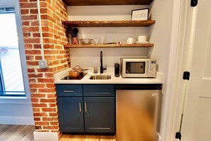Fridge, microwave, coffee/tea maker, cookware/dishes/utensils