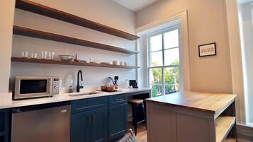 Fridge, microwave, coffee/tea maker, cookware/dishes/utensils