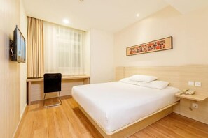 A hotel room with a bed, a desk, a chair, a TV, and a painting on the wall. - Hanting Hotel (Wuxi Henglong Square) (Wuxi)
