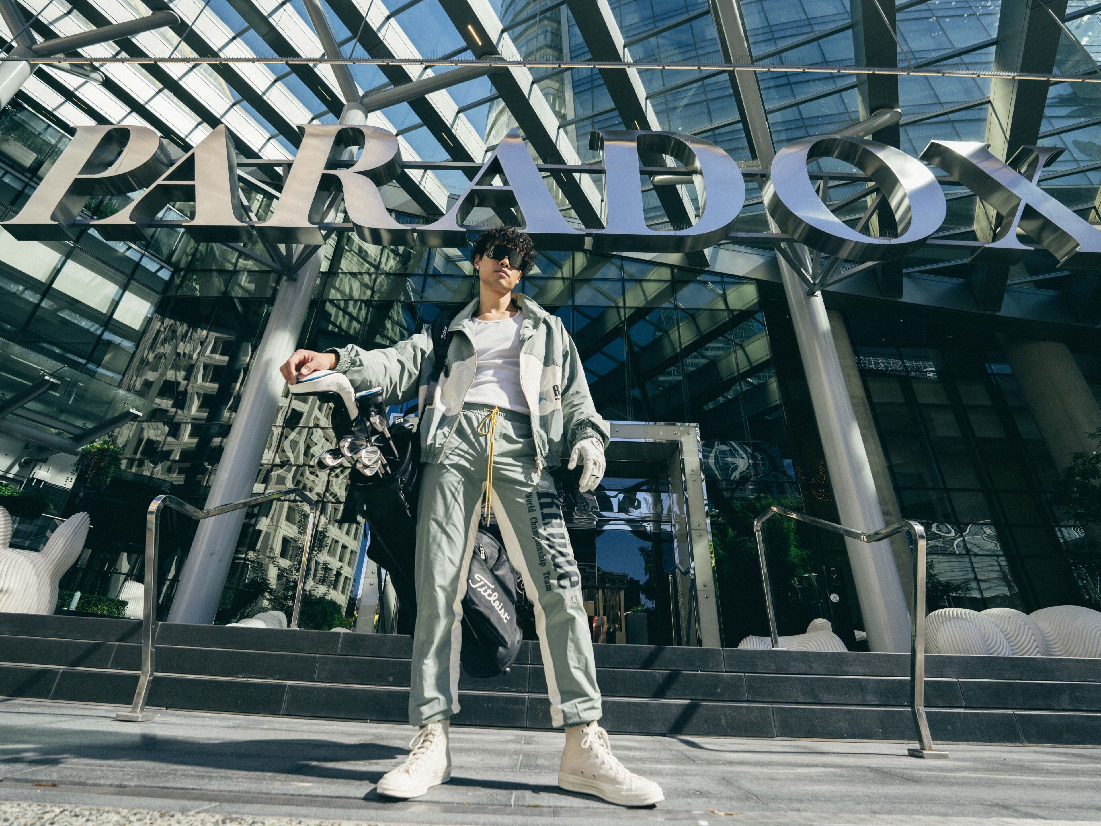 A person standing in front of a building with the word "PARADOX" prominently displayed.